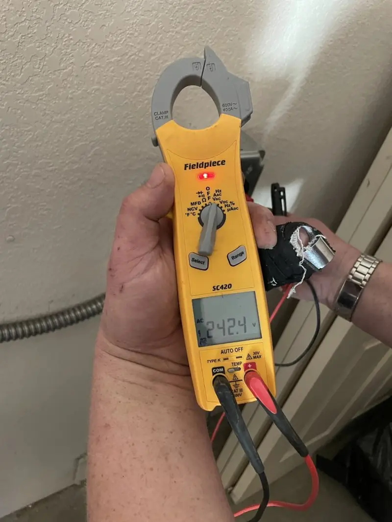 Voltage testing with clamp meter during Electrical Installation Services in Arlington